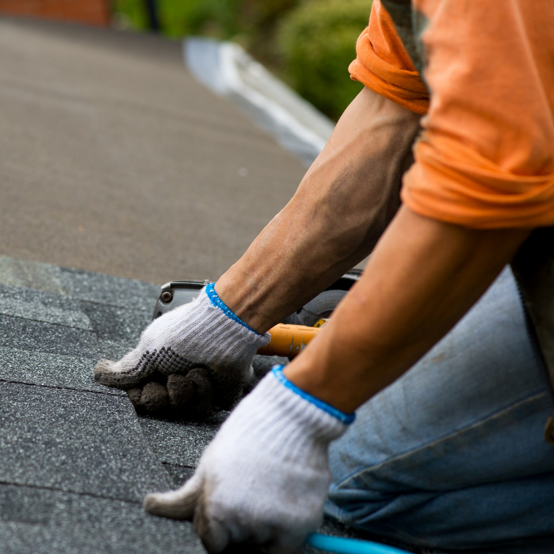 A Roofer Installs Shingles.