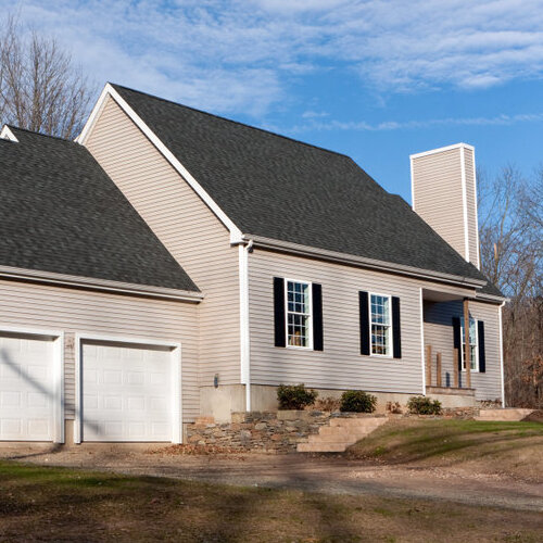 Modern home with tan vinyl siding.